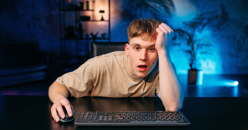 A player staring at a screen blankly, posture slightly hunched, showing subtle signs of fatigue or disconnect after some long gaming sessions