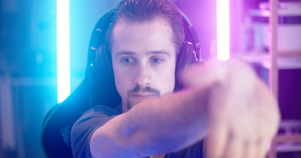 A gamer mid-stretch with palm pulled gently back, showing intentional joint recovery to alleviate gamer pains