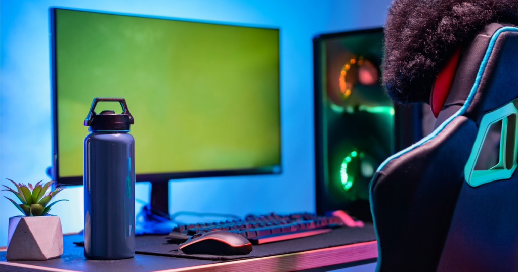 Desk with hydration bottle, supplements, and screen turned off